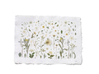 A square white paper print with irregular deckled edges, featuring a delicate botanical illustration of wildflowers and leaves in muted green, yellow, and beige tones, shown on a plain white background with Erbario in the bottom right corner