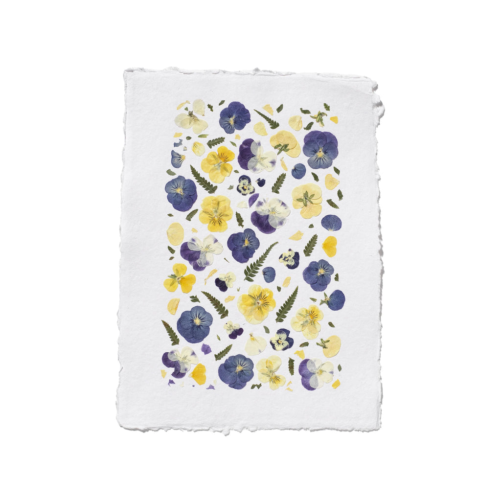 A square white textured paper with yellow and purple pansies with green leaves on a white background.