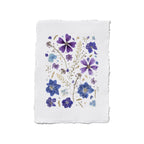 A square white paper art print with a rustic, slightly rough edge, featuring a delicate floral design of purple and blue flowers with green stems on a white background.