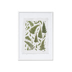 A framed botanical art featuring green ferns on a textured off-white paper background, enclosed in a white frame against a solid white backdrop.