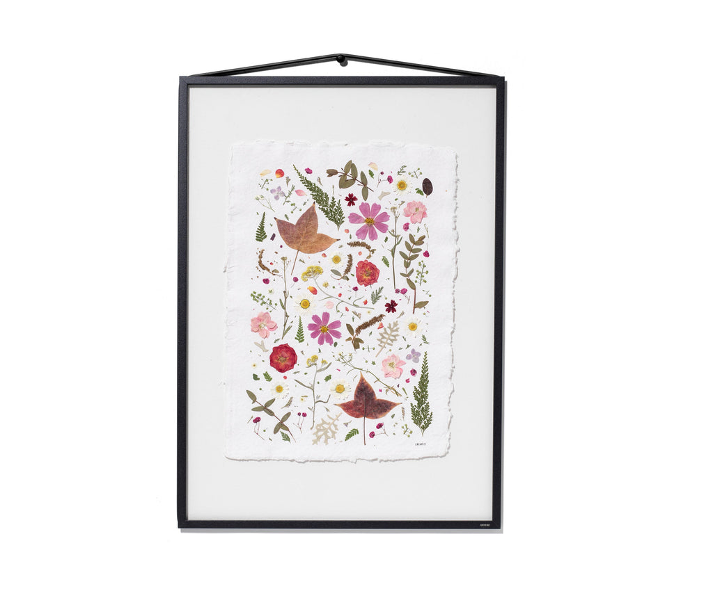 A framed botanical art featuring colourful flowers, leaves, and birds on a white textured background, enclosed in a black frame with a hanging loop at the top.