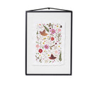 A framed botanical art featuring colourful flowers, leaves, and birds on a white textured background, enclosed in a black frame with a hanging loop at the top.